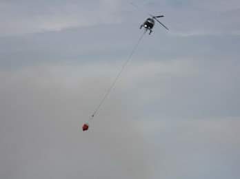 Provincial fire crews and one helicopter, and several fire departments, are responding to a wildfire near Dean