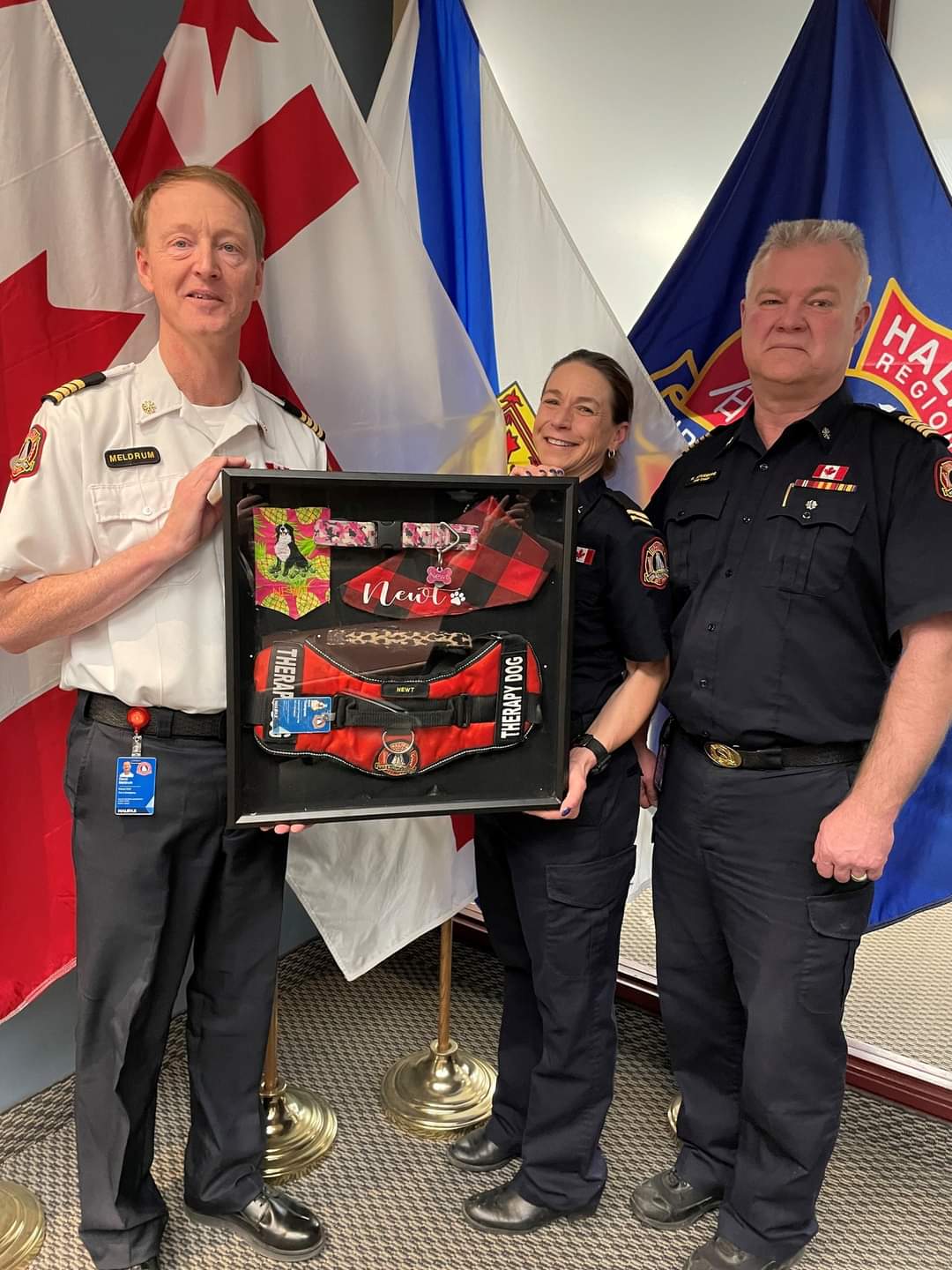Chief Ken Stuebing and Deputy Chief Dave Meldrum presented Captain Annette Thompson with a shadowbox created in memory of Newt