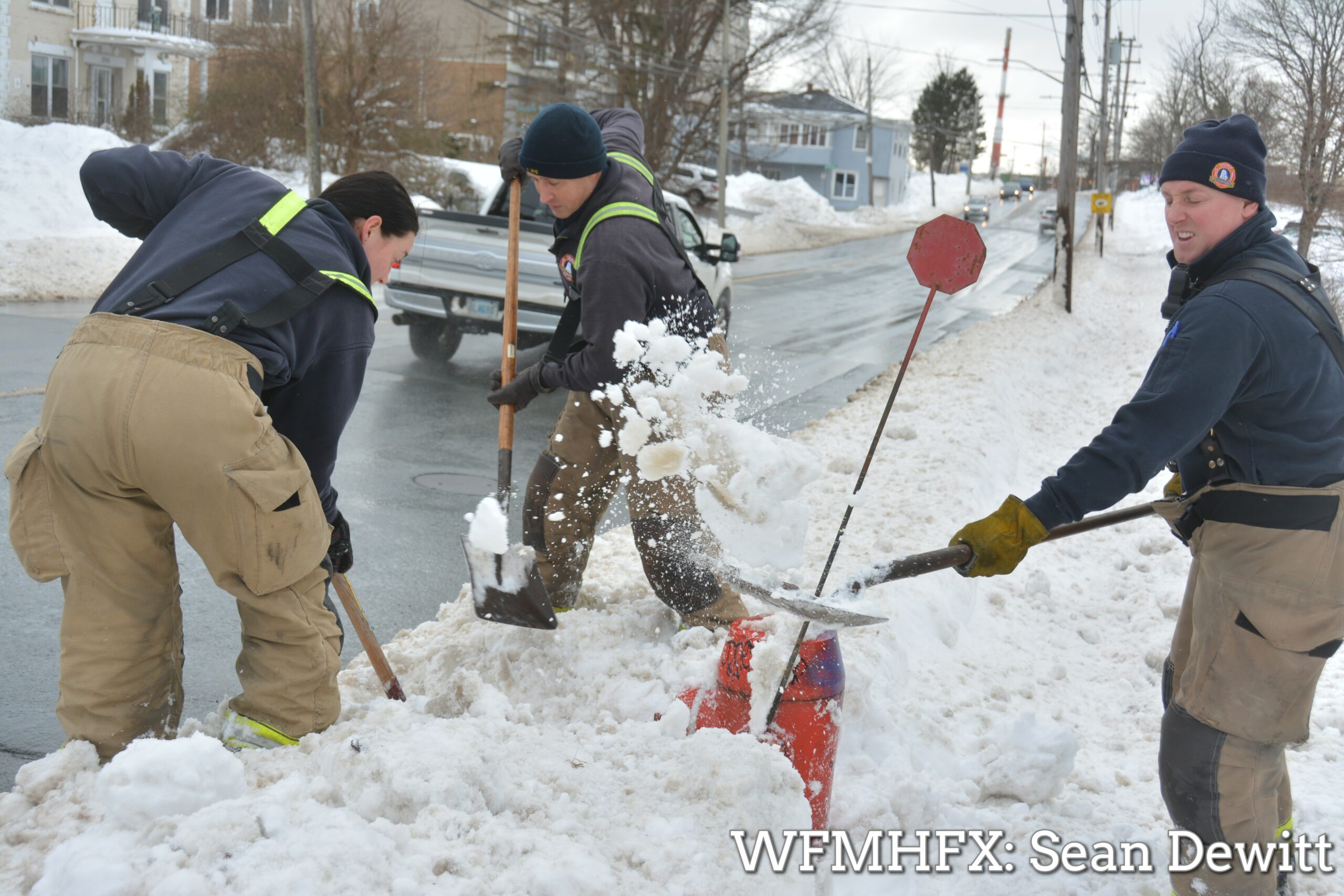 Members from HRFE STN 15 (Woodside) take some time to clear out snow buried fire hydrants in their response zone