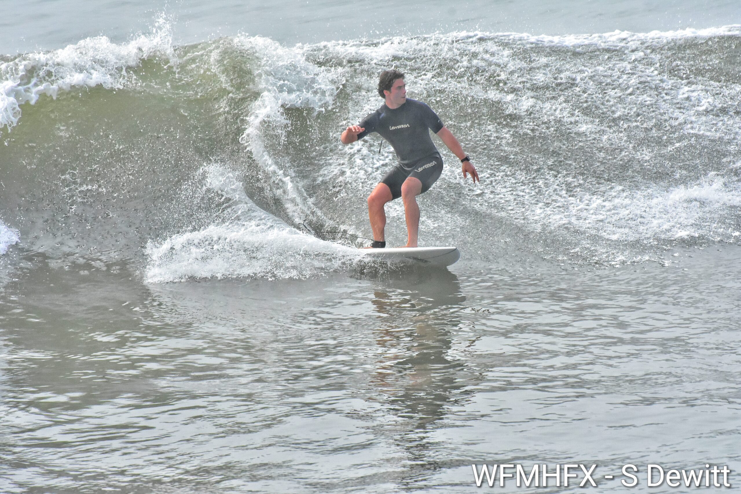 Surfers take advantage of the waves, compliments of Ernesto