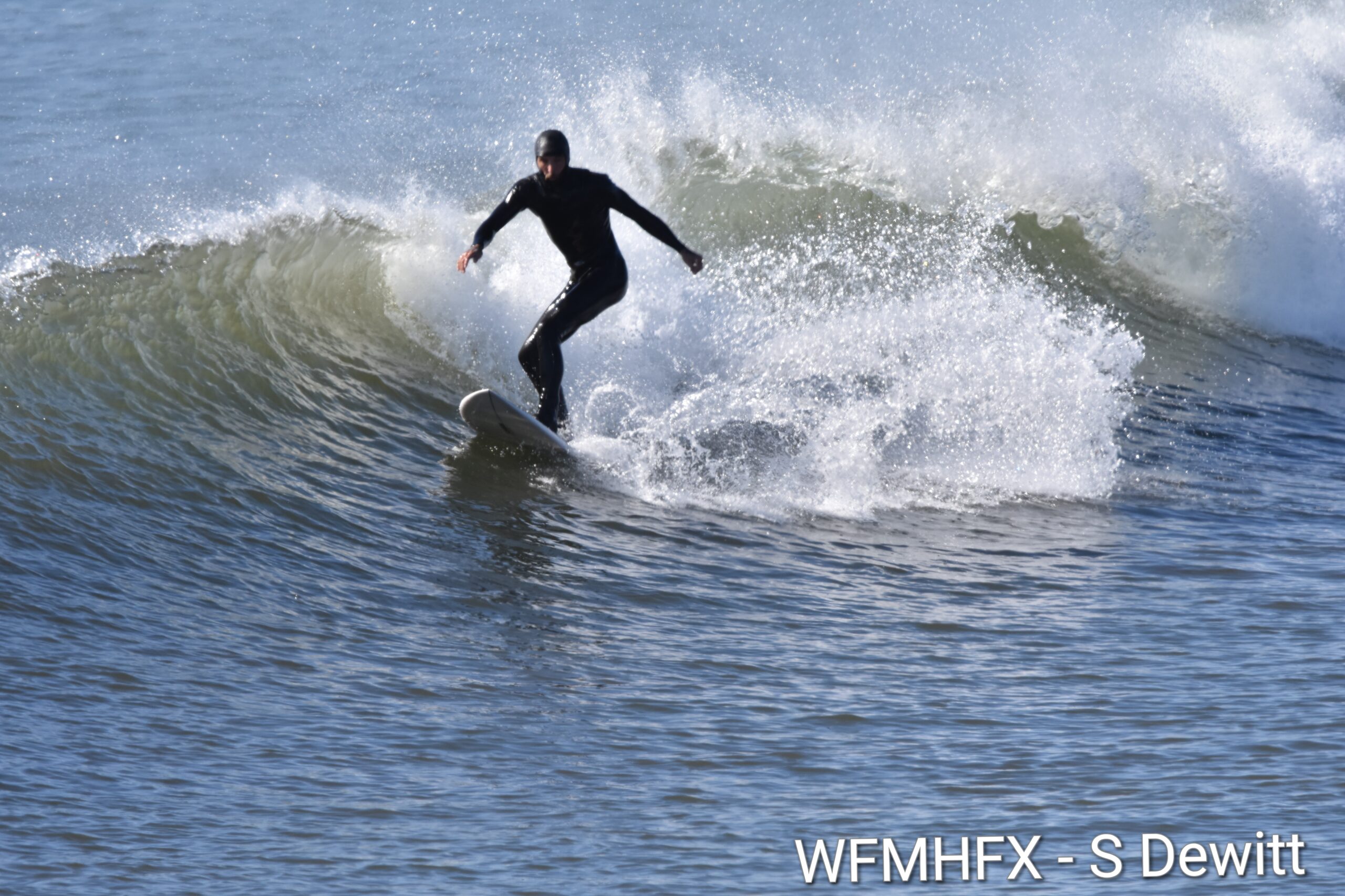 In photos - Great fun at Cow Bay as surfers take advantage of a sunny and mild fall day with increasingly bigger waves as Hurricane Humberto slowly passes well off the coast of NS